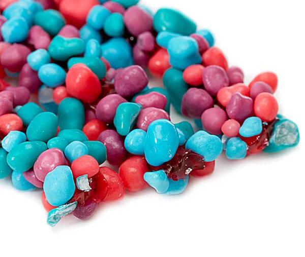 Nerds Rope Very Berry candy featuring a soft chewy fruity gummy rope covered in colorful crunchy NERDS candy pieces.