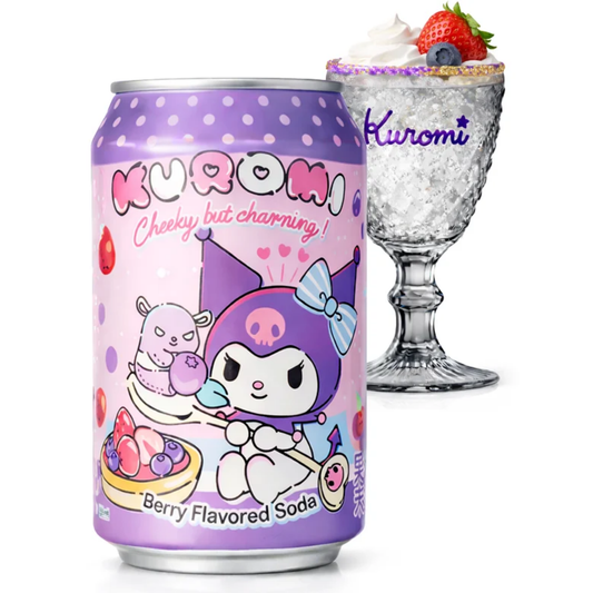 A can of Kuromi Berry Flavored Soda is shown in front of a glass dessert glass with whipped cream, a strawberry, and blueberries. The can features a light pink and purple cartoon design of Kuromi, with the text 'Kuromi' and 'Berry Flavored Soda'.
