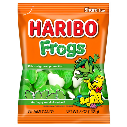 A bag of Haribo Frogs gummi candy, featuring a bright orange wrapper with the brand name in large red letters, green 'Frogs' text, a cartoon green frog, and a yellow character.