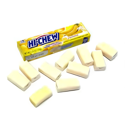 A pack of Hi-Chew banana-flavored gum alongside several unwrapped pale-yellow rectangular gum pieces.