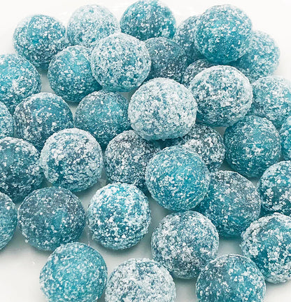Close-up of blue raspberry Mega Sour candy balls with intense sugar coating