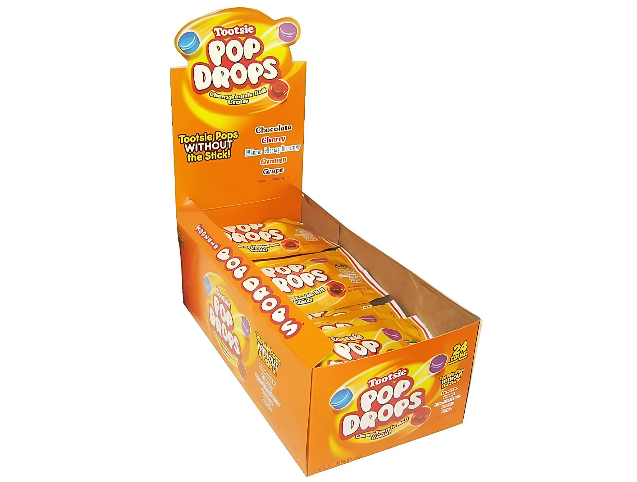 A box of Tootsie Pop Drops featuring colorful assorted hard candy shells with chewy chocolatey Tootsie Roll centers in Chocolate, Cherry, Blue Raspberry, Orange, and Grape flavors.